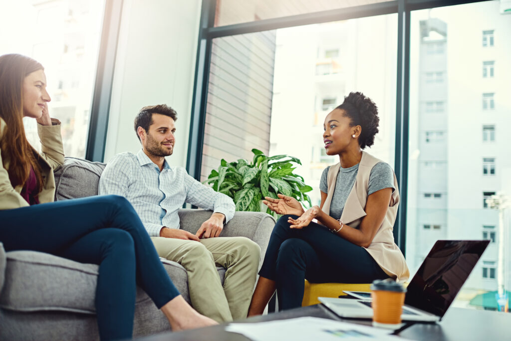 Business people, teamwork and meeting for brainstorming, laptop and creative agency with social impact. Journalist, graphic design and editing with company development and culture article with ideas.