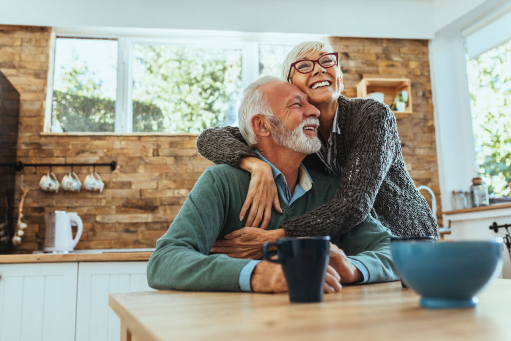 Shot of an older woman hugging her husband. Older people are affected by Aging Infrastructure